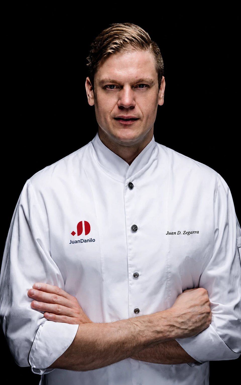 Juan Danilo Zegarra Presser in chef's whites with the JuanDanilo emblem